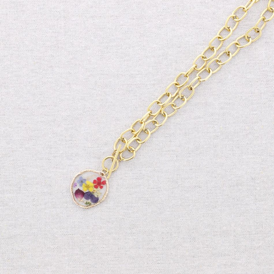 STEEL NECKLACE WITH DRIED FLOWER PENDANT
