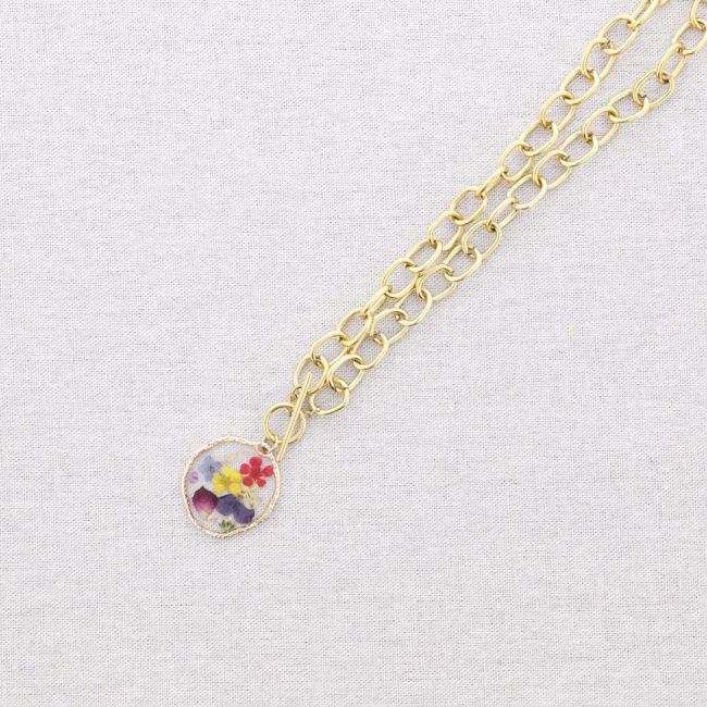 STEEL NECKLACE WITH DRIED FLOWER PENDANT