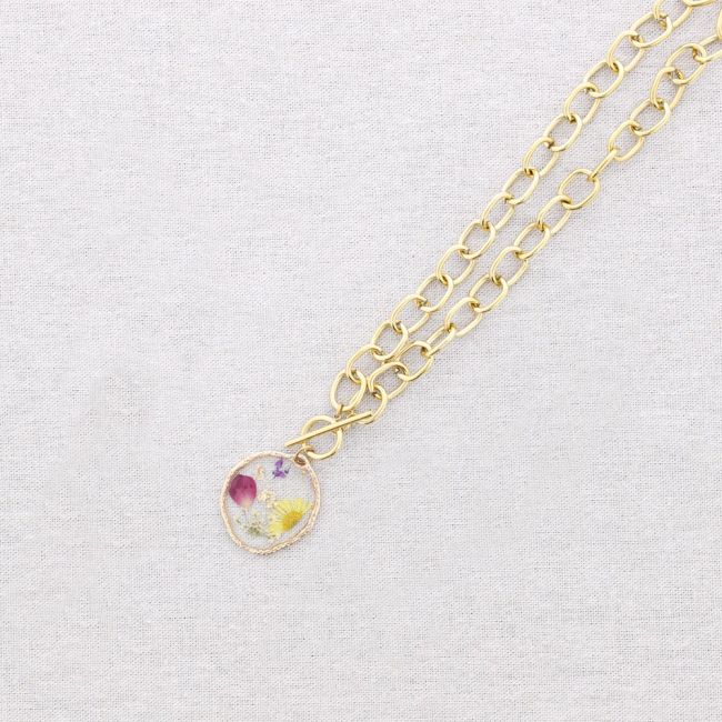 STEEL NECKLACE WITH DRIED FLOWER PENDANT