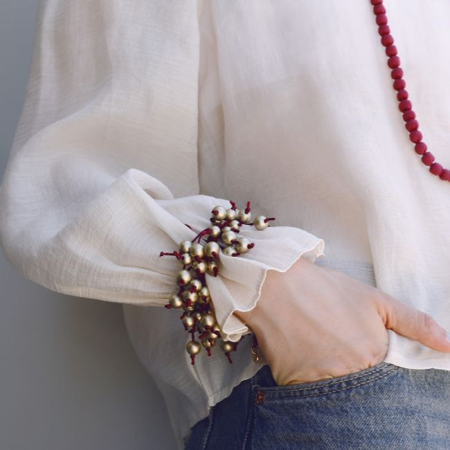 FRINGE BRACELET WITH METAL FINISH BALLS