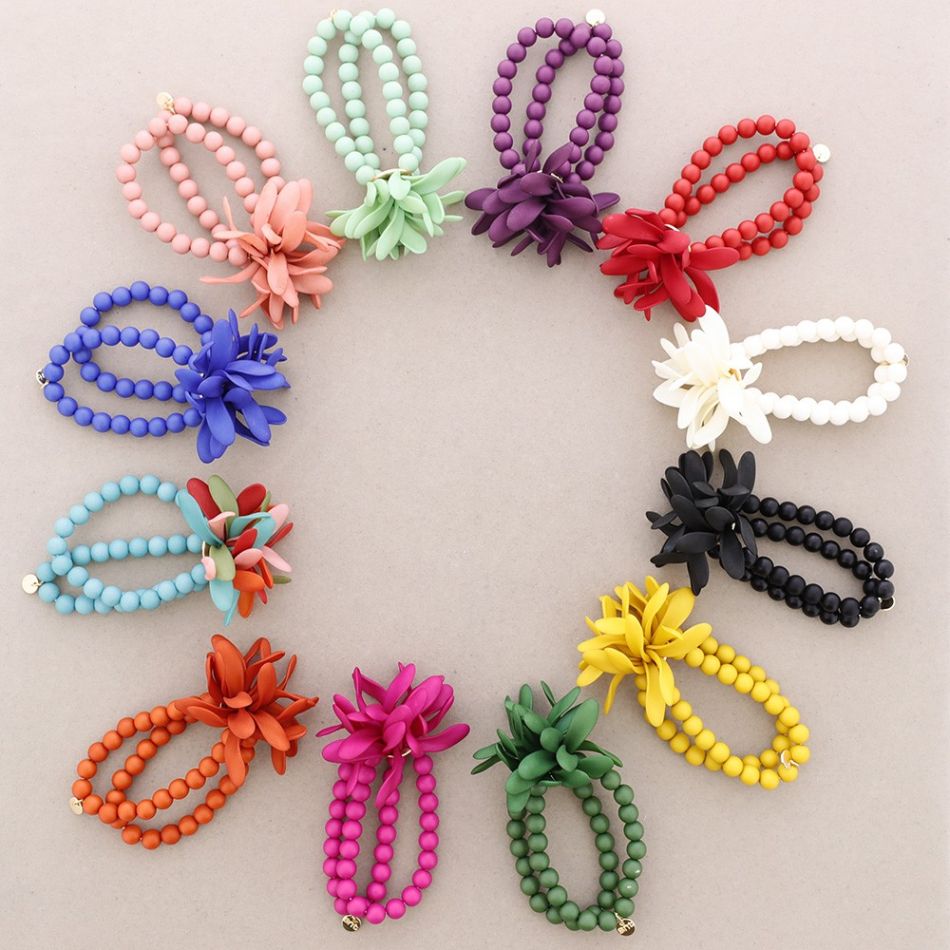 PULSERA ELÁSTICA BOLITAS FLOR RESINA